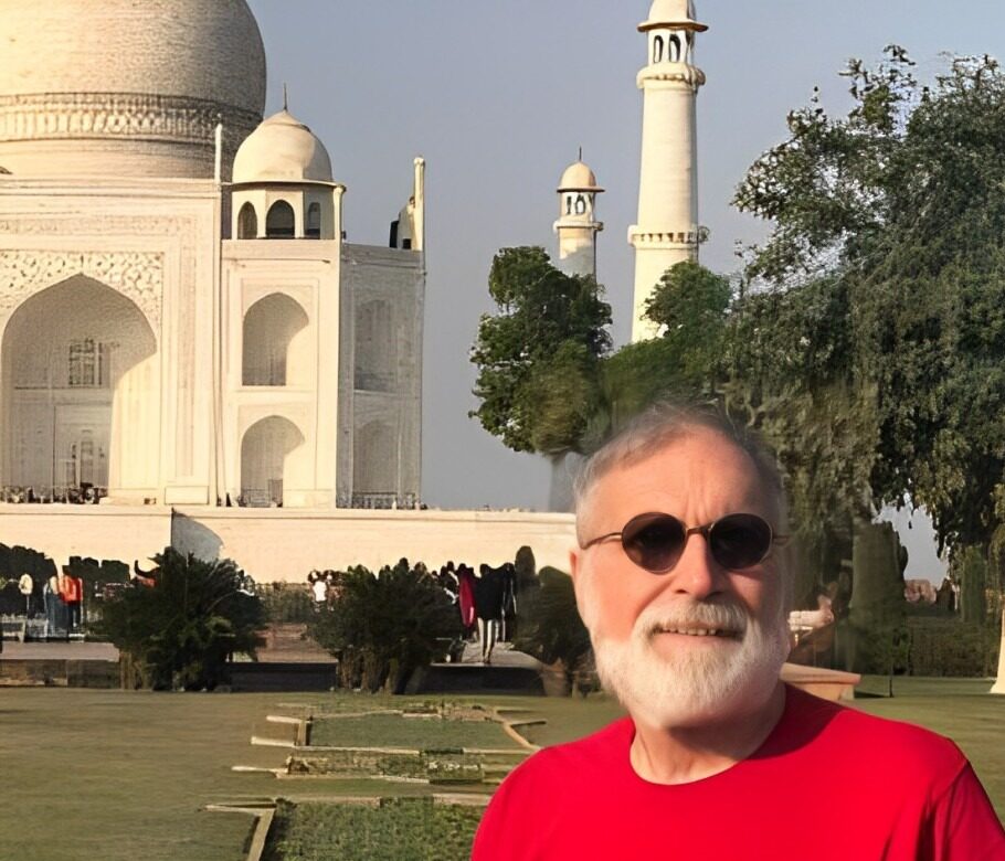 Crop image of a man sitting on a bench in front of a building