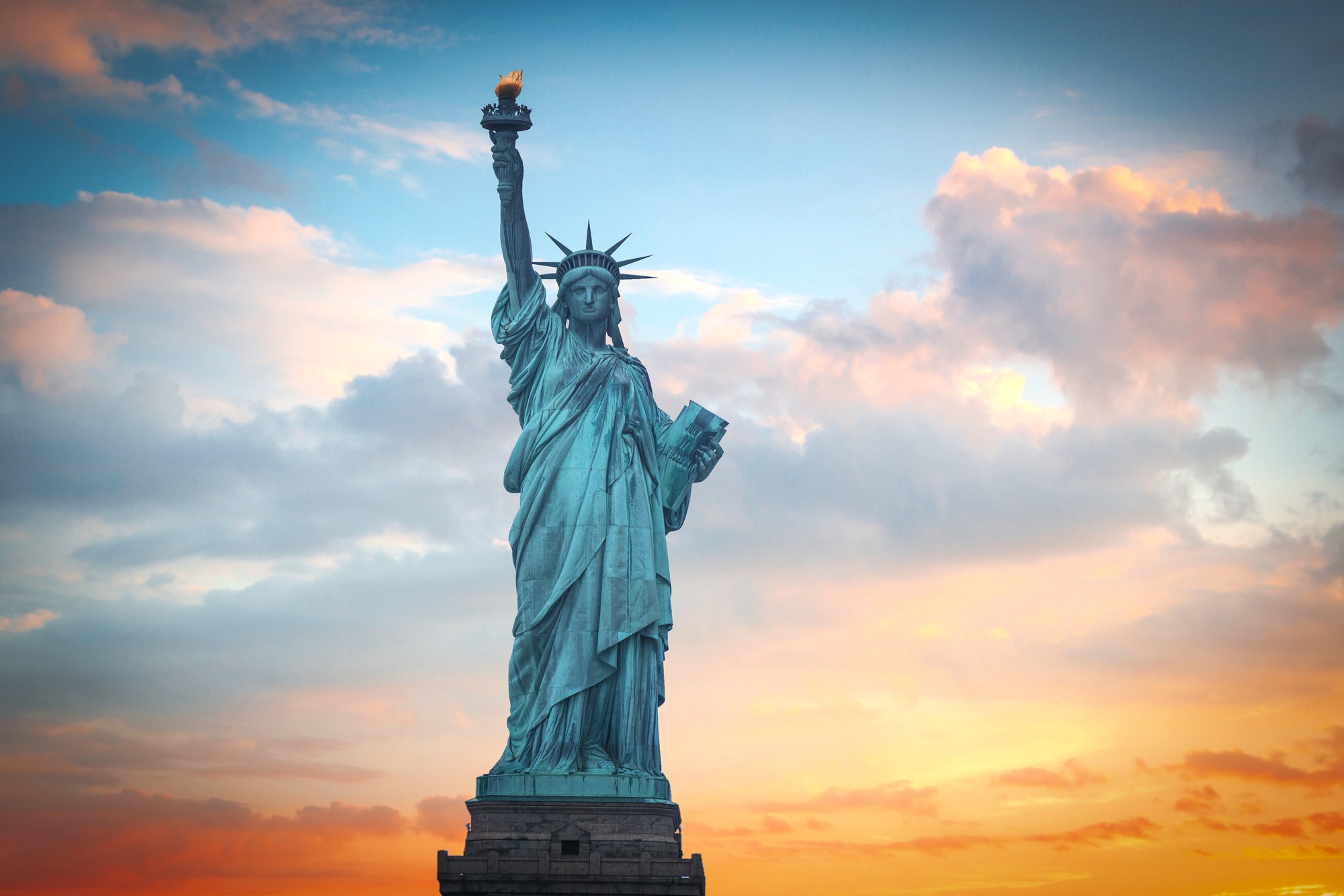 Statue of Liberty on the background of colorful dawn sky